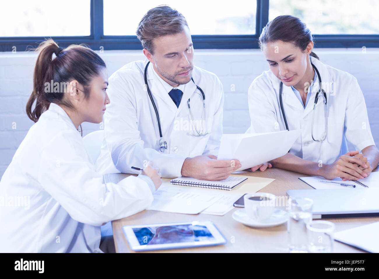 Medical team sitting discussing table hi-res stock photography and ...