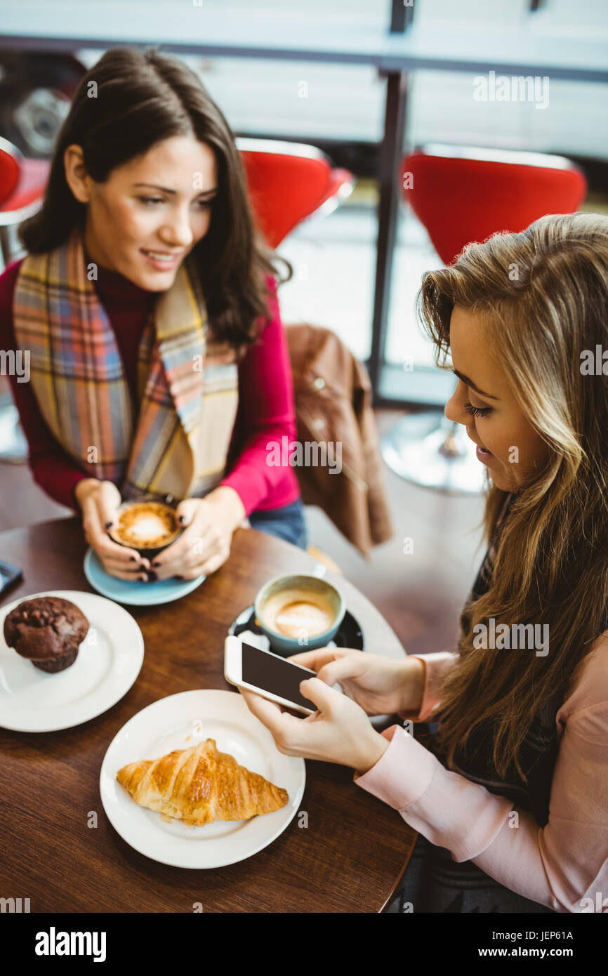 Friends using their smartphone Stock Photo - Alamy