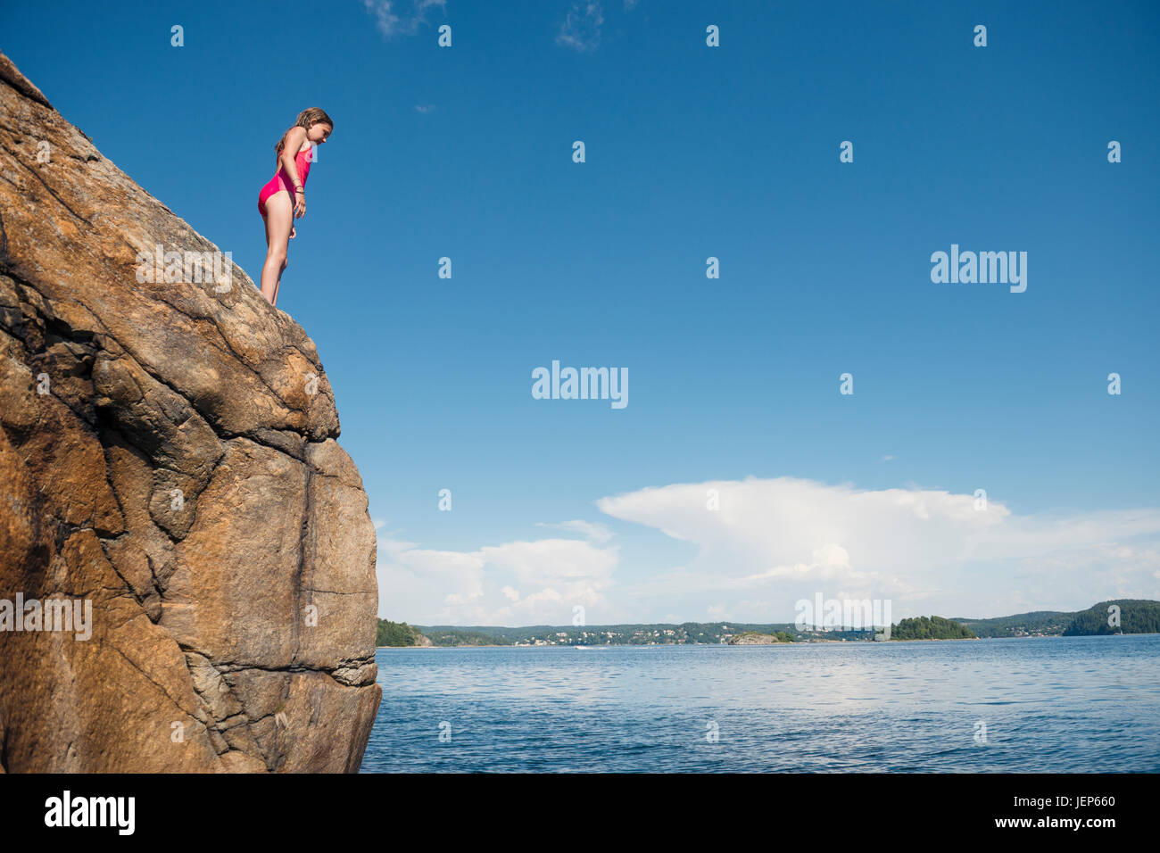 Girl standing on cliff Stock Photo Alamy