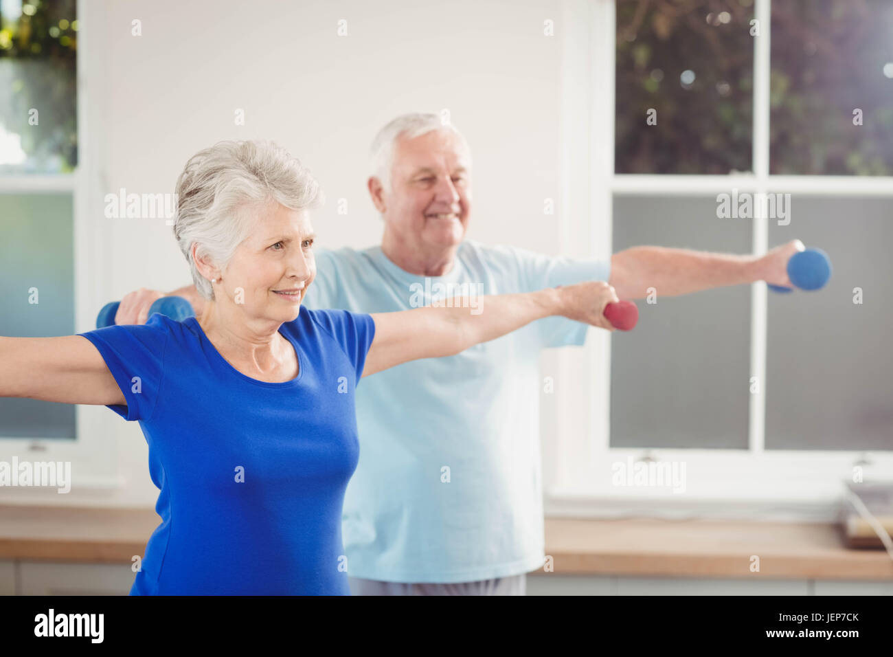 Senior couple performing stretching exercise Stock Photo - Alamy