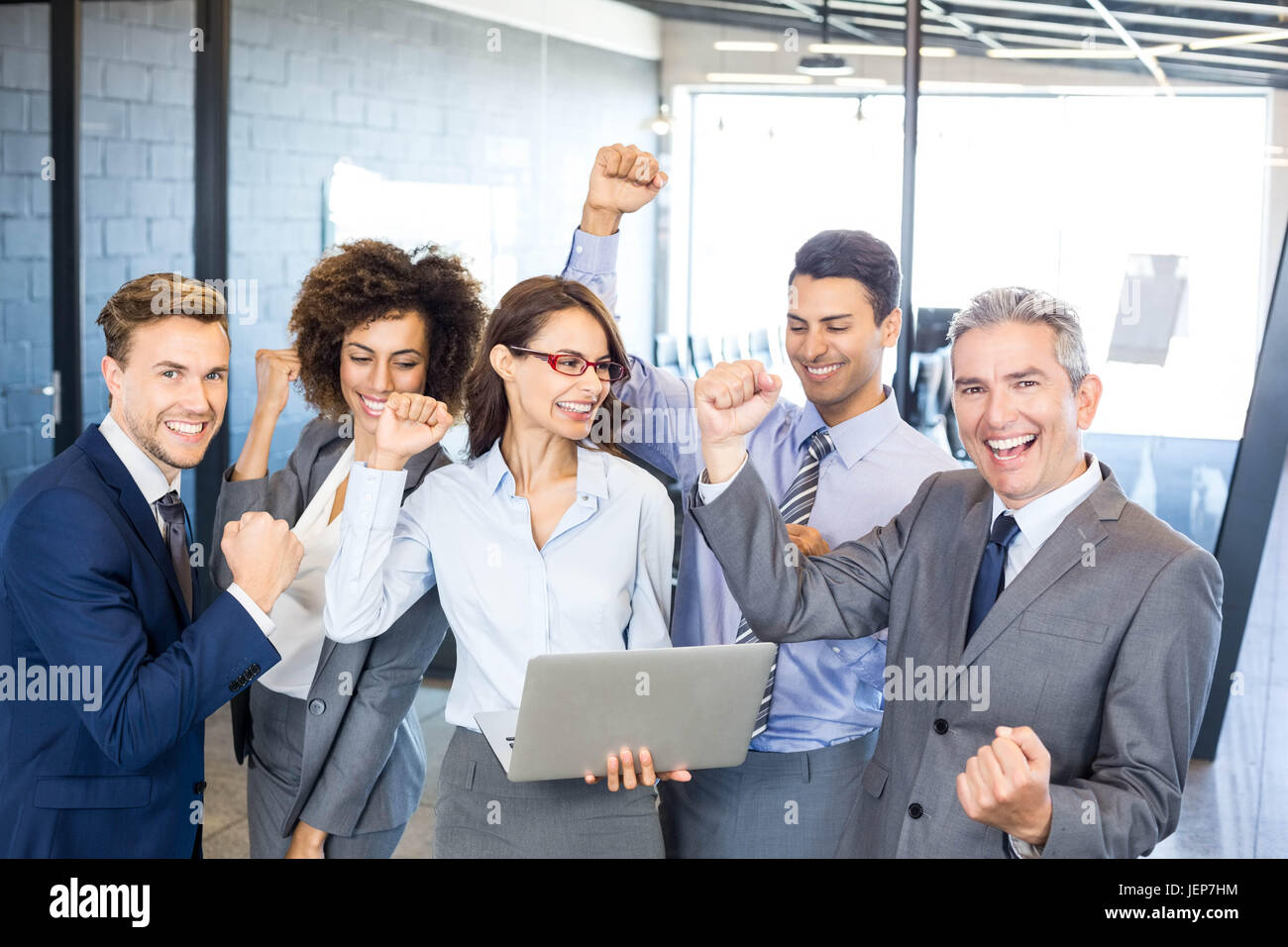 Happy business team celebrating a success Stock Photo - Alamy