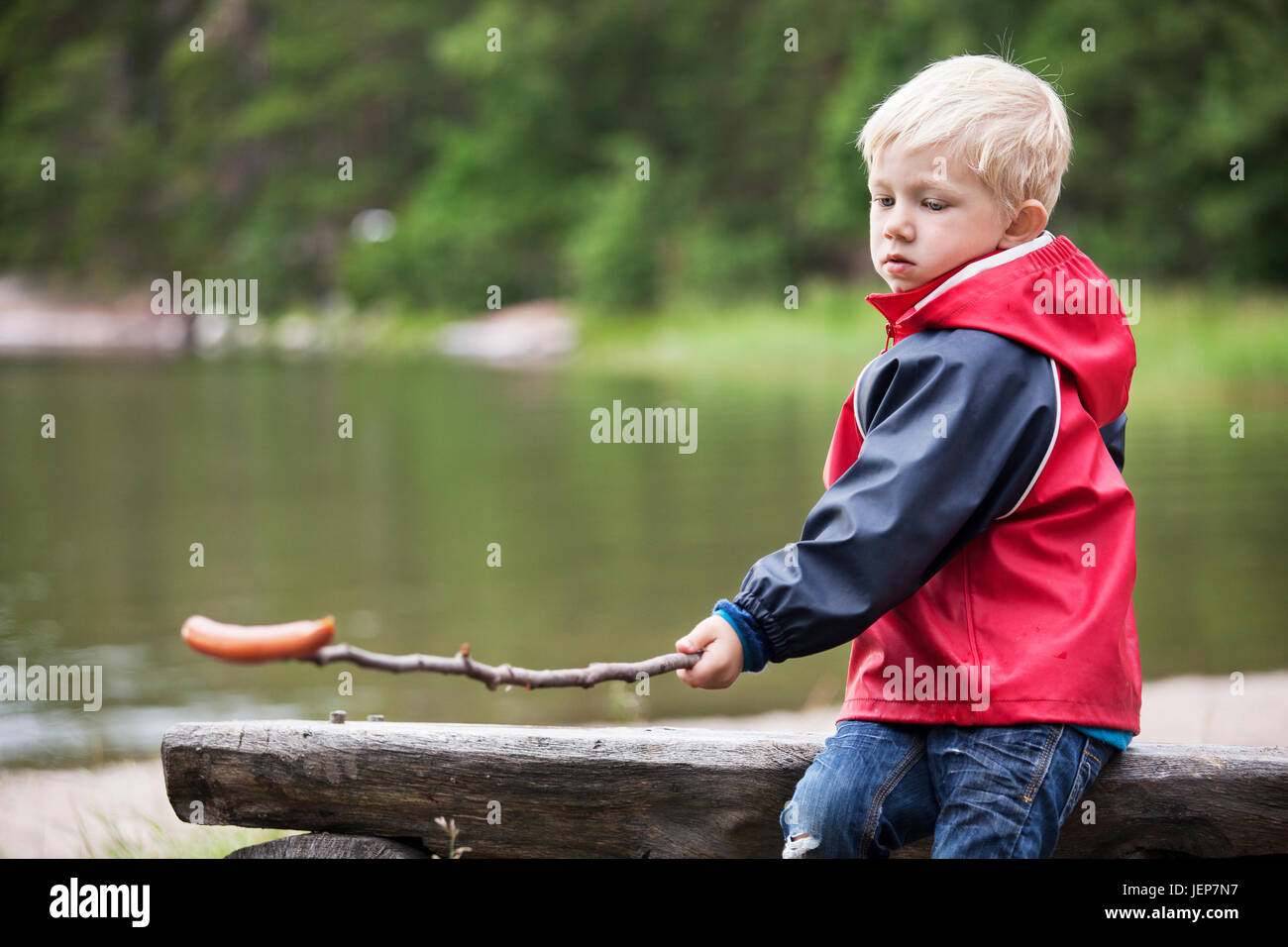 Boy with sausage on stick Stock Photo