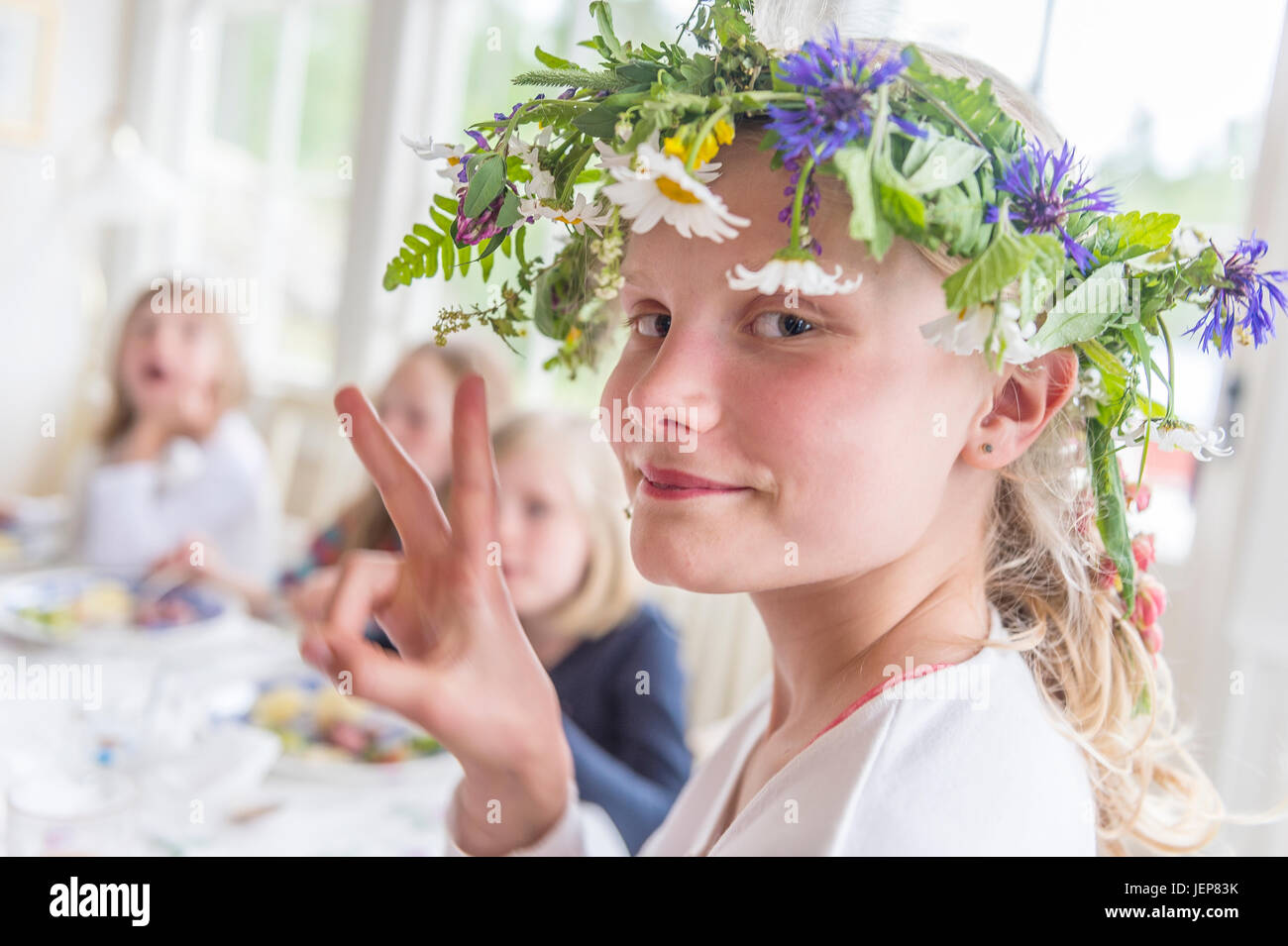 Girl wearing flower wreath Stock Photo - Alamy