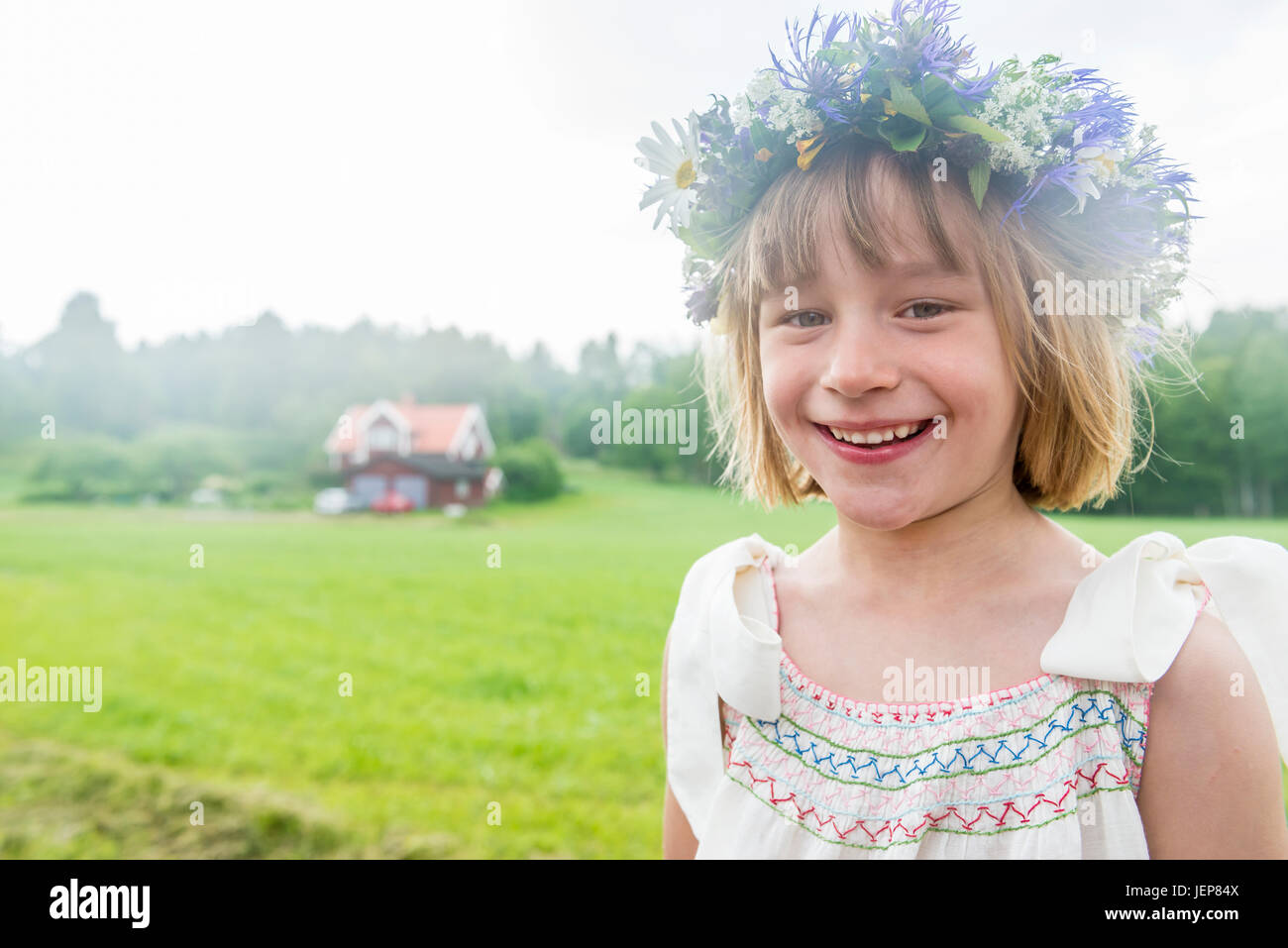 Portrait of girl wearing flower wreath Stock Photo - Alamy