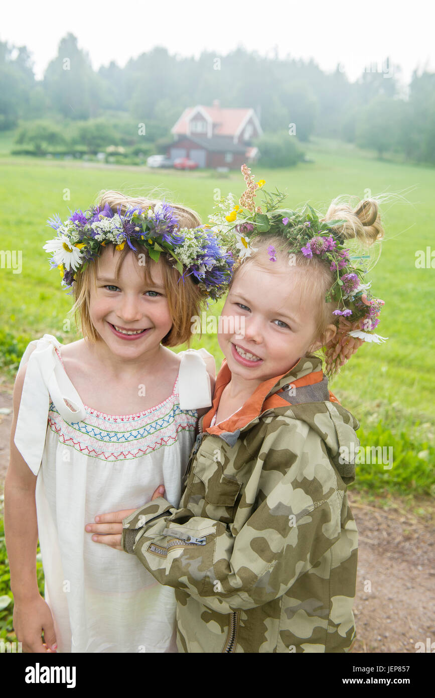 Smiling girls wearing flower wreath Stock Photo - Alamy