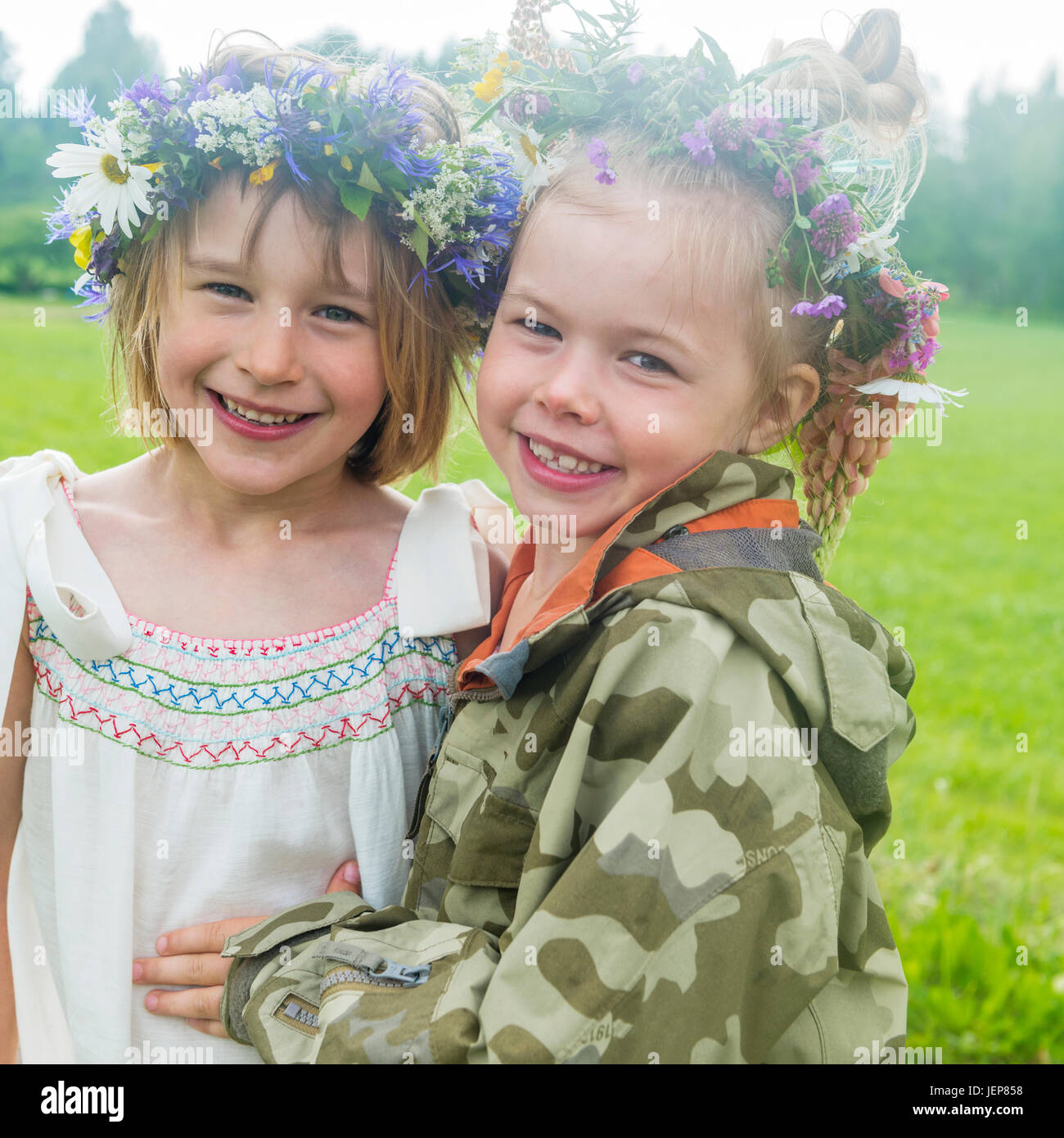 Smiling girls wearing flower wreath Stock Photo - Alamy