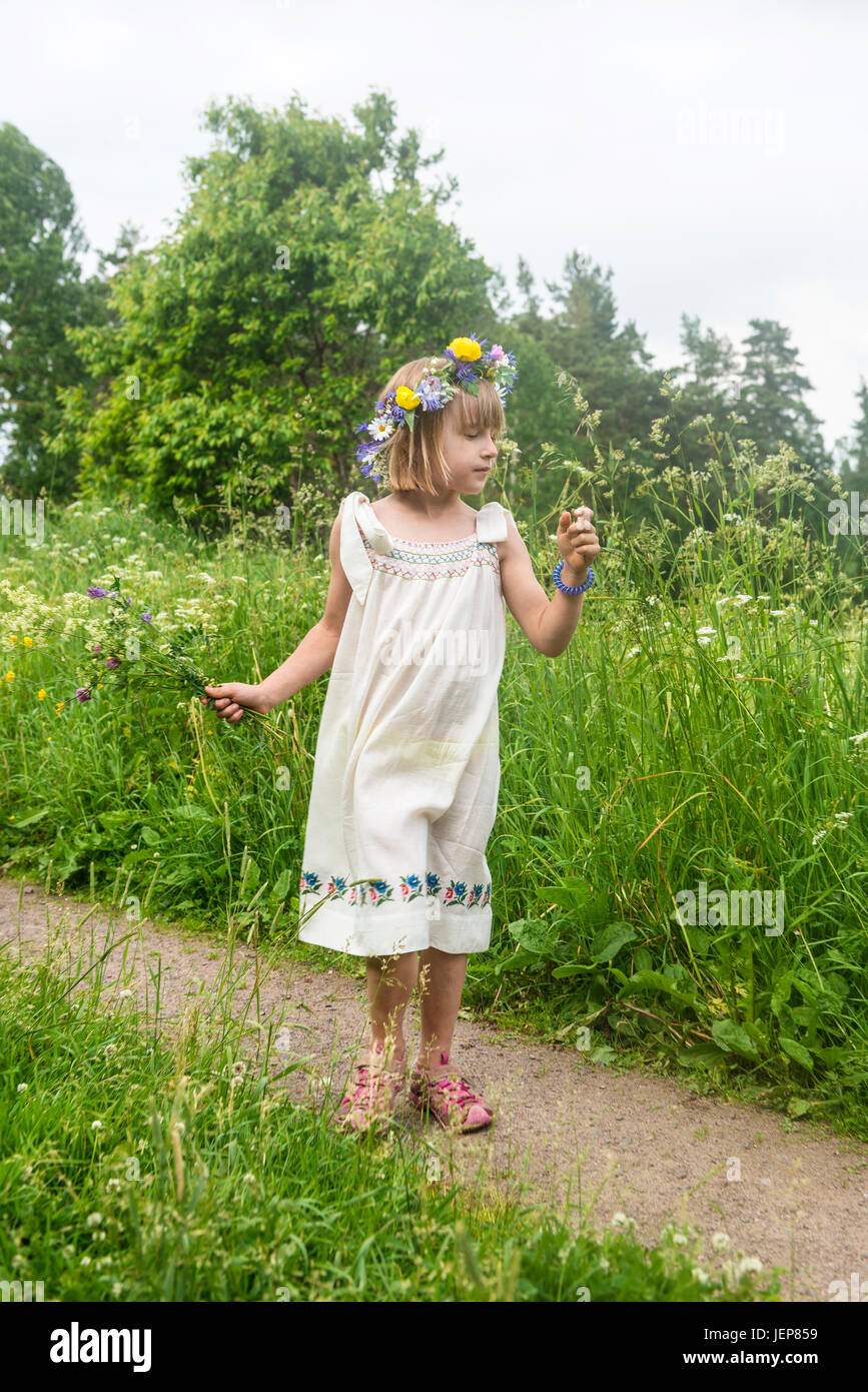 Girl wearing flower wreath on meadow Stock Photo - Alamy