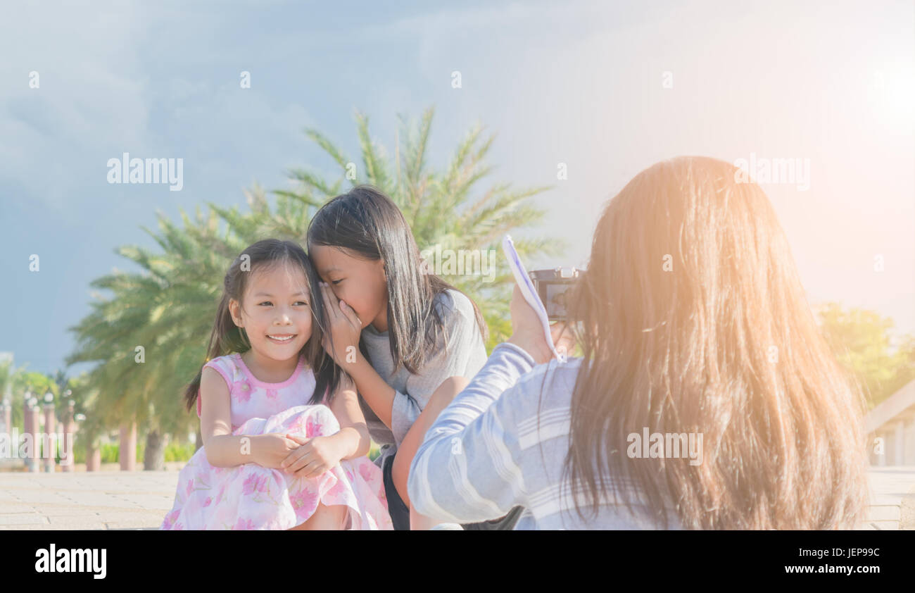 Mother and her daughter take a photo in the garden. Concept family relation. Stock Photo