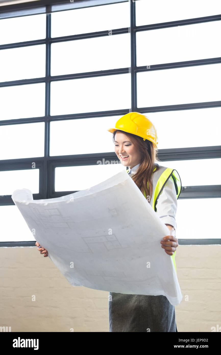 Architect looking at blueprint Stock Photo - Alamy