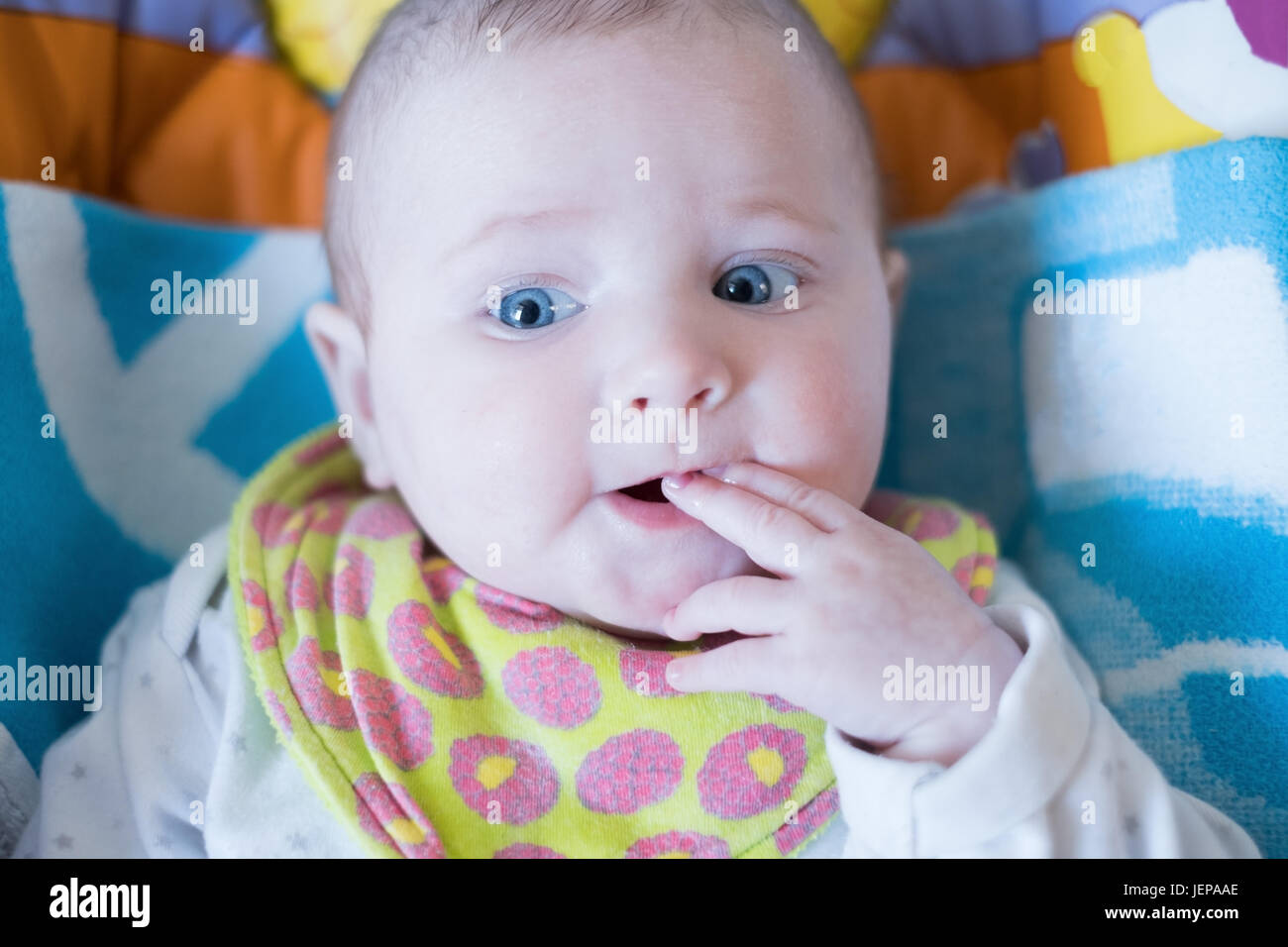 Portrait of the child with a finger in a mouth Stock Photo