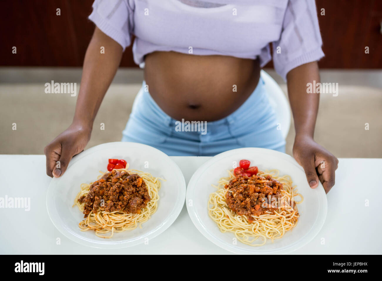 Pregnant woman with plate of pasta Stock Photo Alamy