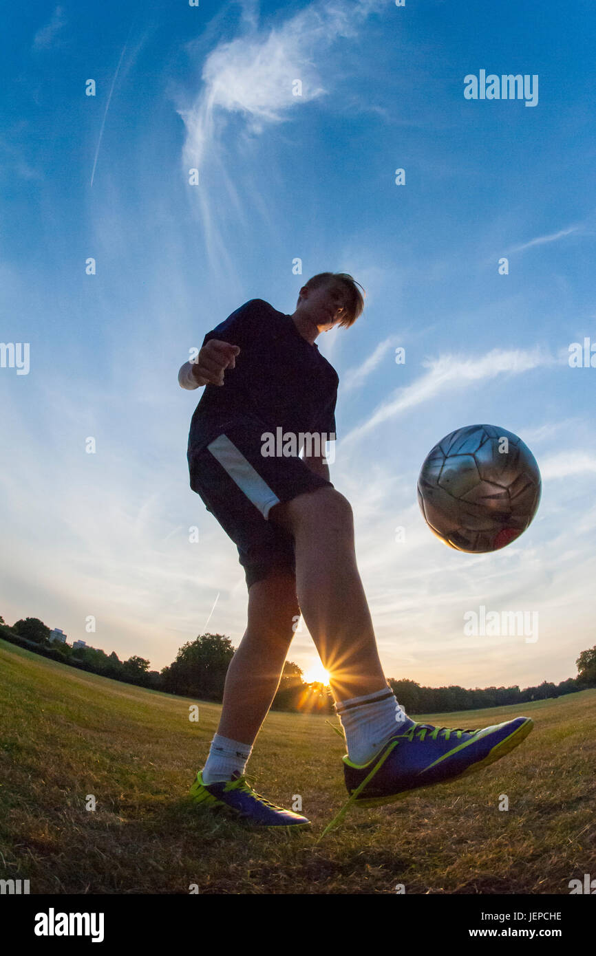 A Young Boy Playing Football And Practicing His Football Skills