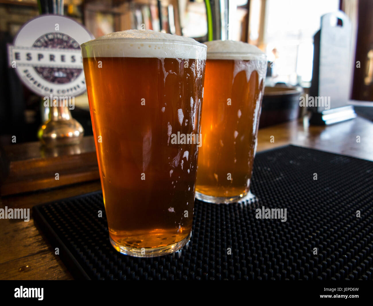TWO PINTS OF BITTER AWAIT DRINKING IN A LONDON PUB Stock Photo