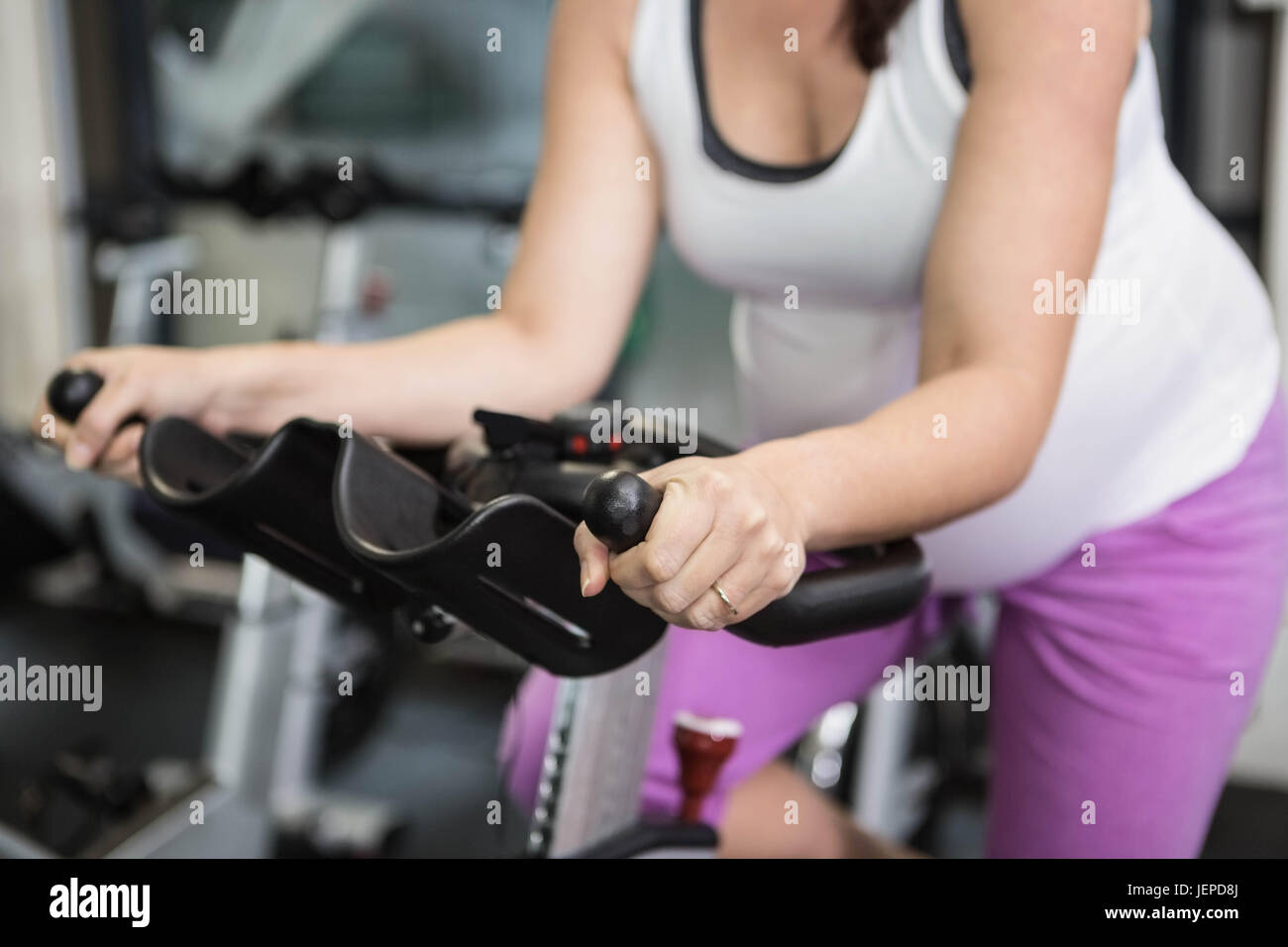 Pregnant woman using exercise bike Stock Photo Alamy