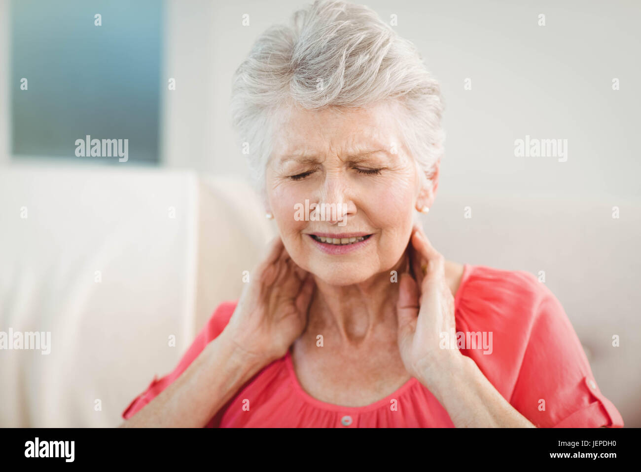 Senior woman suffering from neck pain Stock Photo Alamy