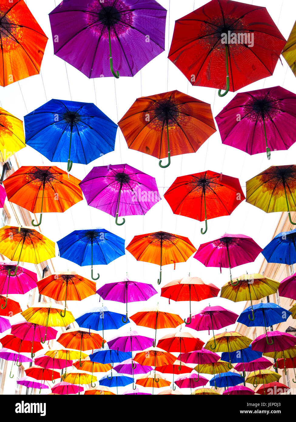Brightly coloured umbrellas hanging in the sky Stock Photo Alamy
