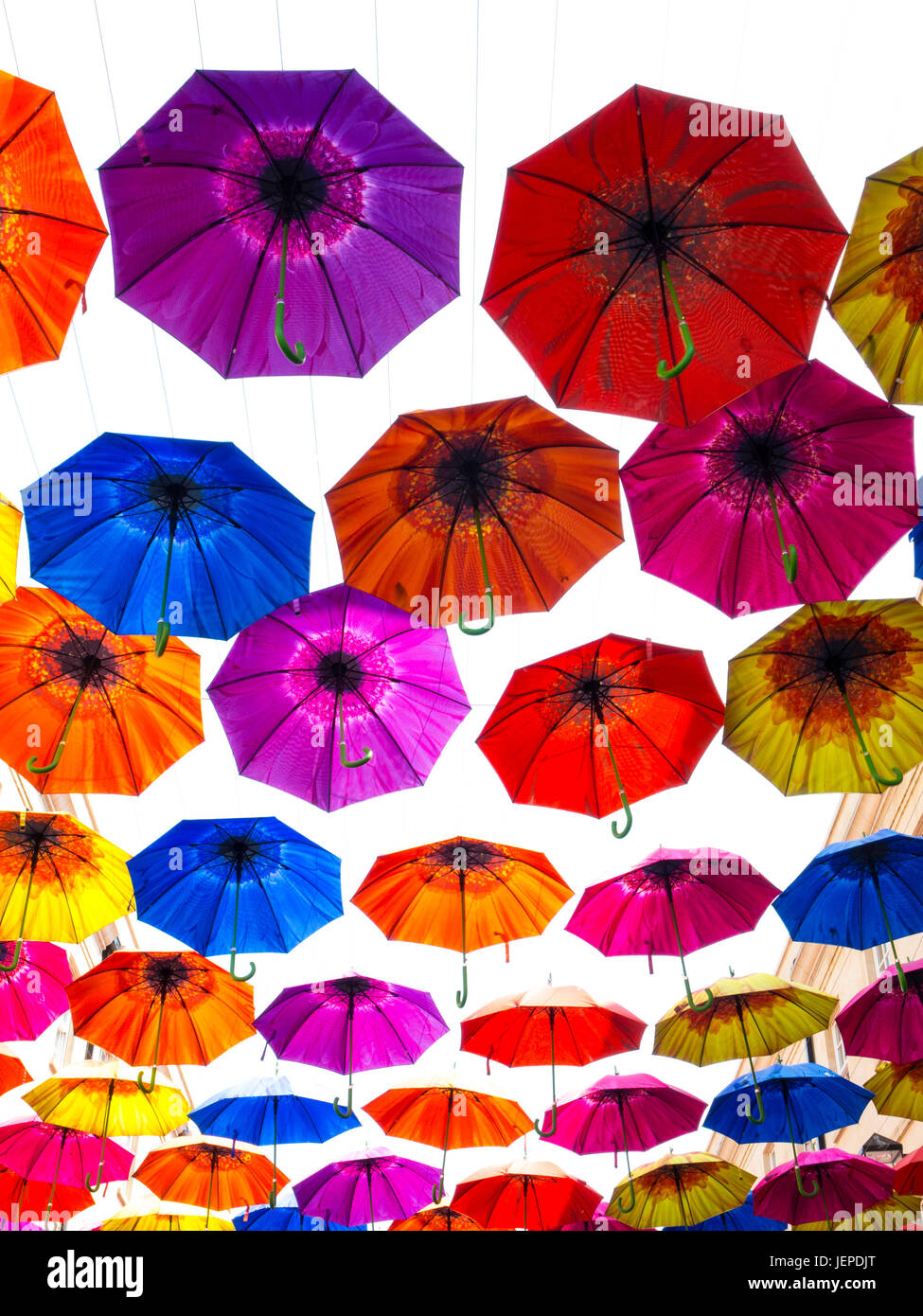 Brightly coloured umbrellas hanging in the sky Stock Photo Alamy