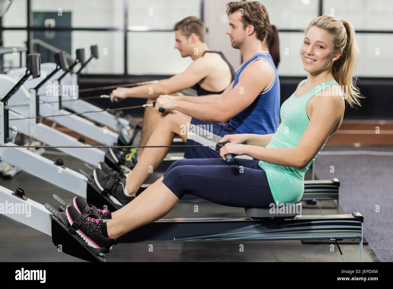 Sportsman is working out on a rowing machine hi-res stock photography ...