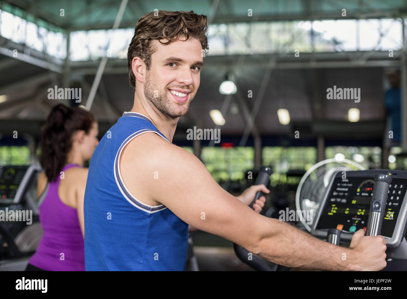 Fit man on elliptical bike Stock Photo