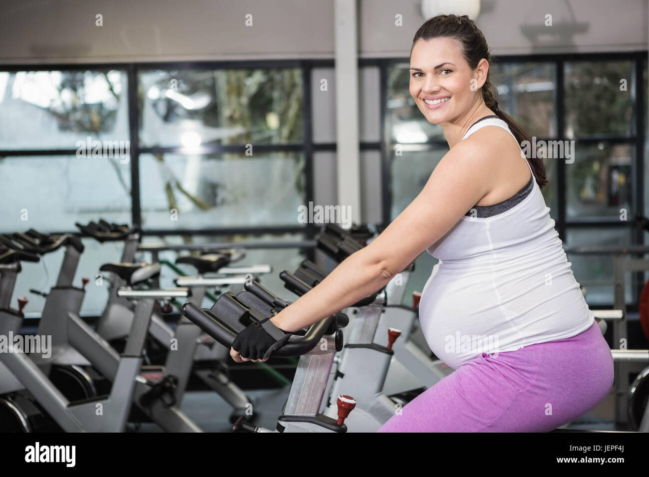 pregnant-woman-using-exercise-bike-stock-photo-alamy
