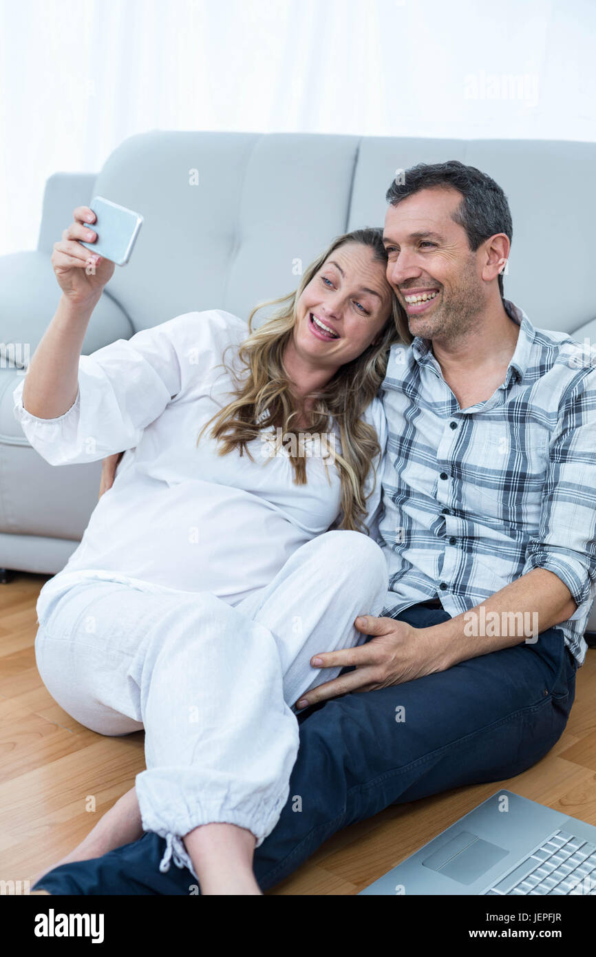 Pregnant couple sitting floor Stock Photo Alamy