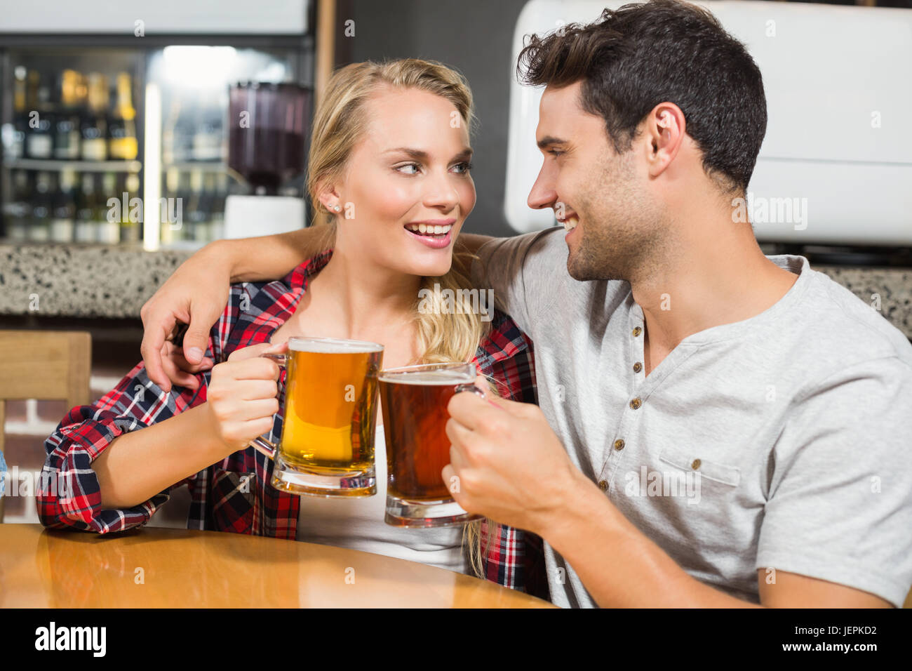 Couple toasting with beers Stock Photo