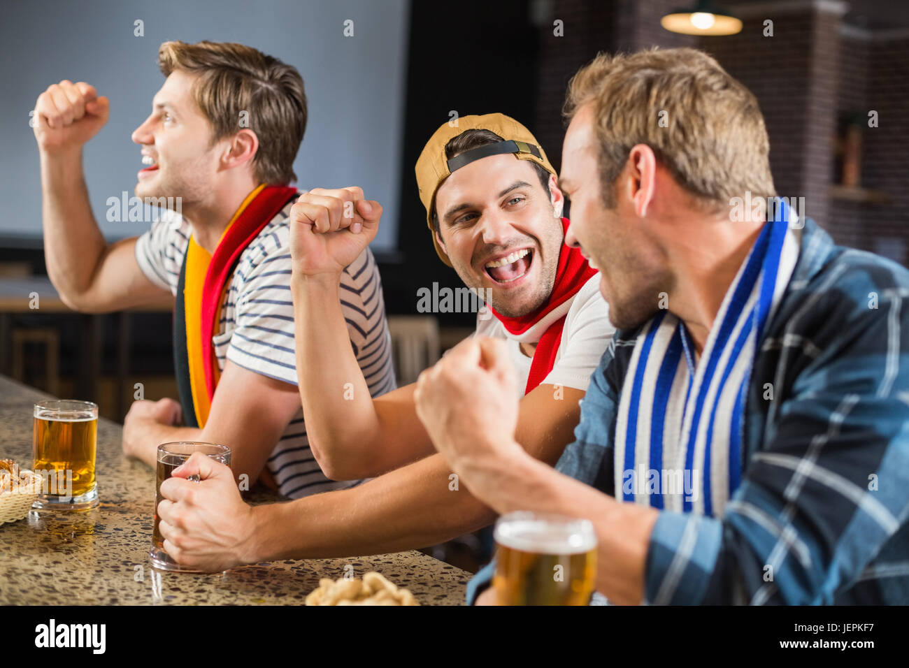 Men cheering with beers Stock Photo