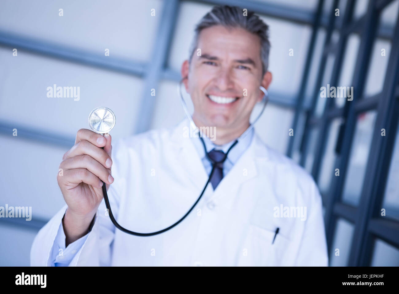 Portrait of male doctor showing stethoscope Stock Photo - Alamy