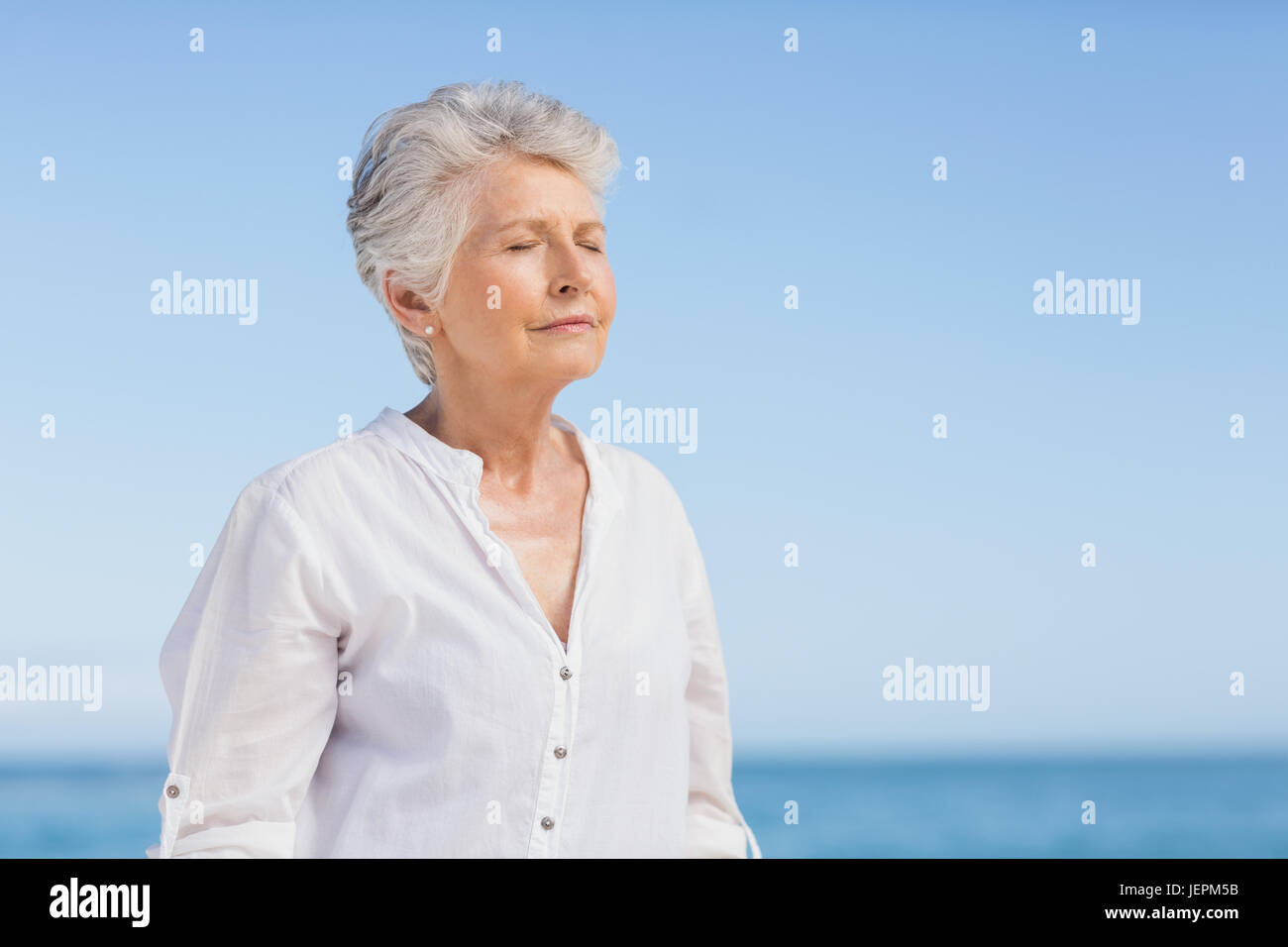 Senior woman relaxing on the beach Stock Photo - Alamy