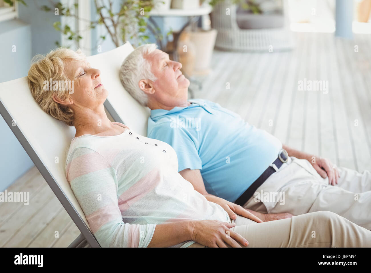 Senior couple relaxing on lounge chair Stock Photo - Alamy
