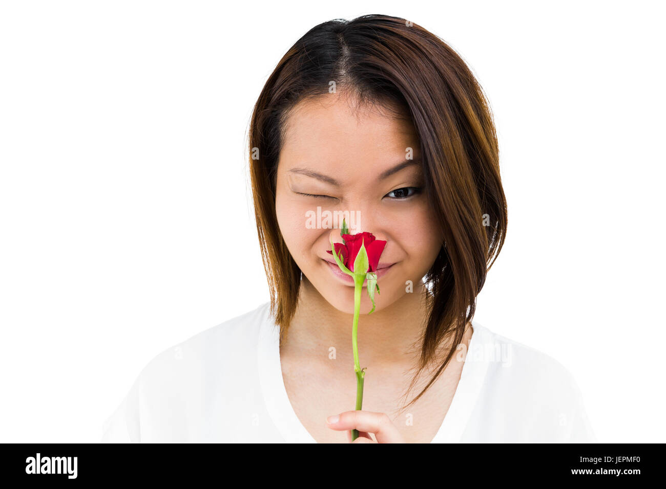 Happy young woman smelling rose Stock Photo - Alamy