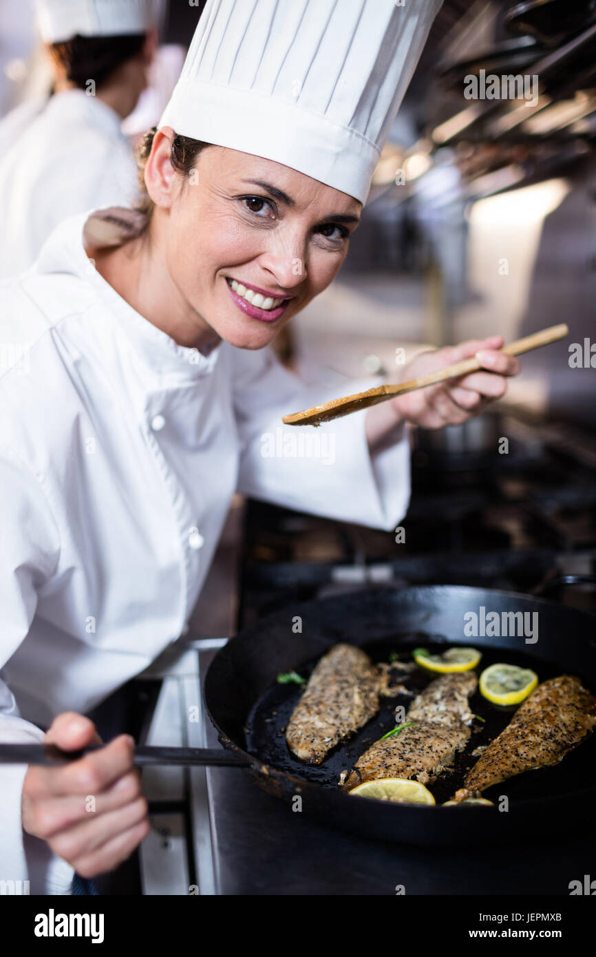 Chef smelling fried fish in the kitchen Stock Photo Alamy