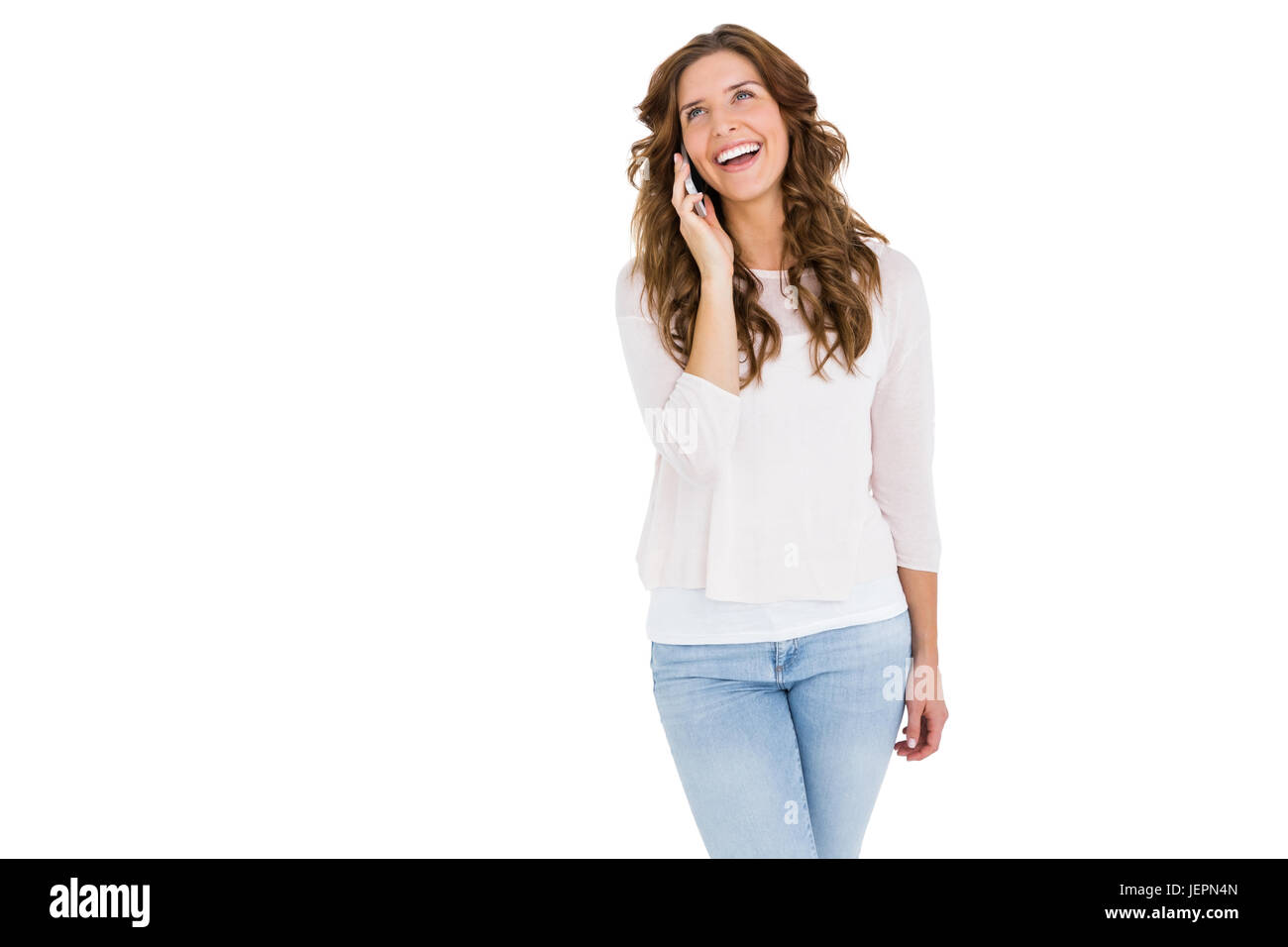 Happy young woman talking on mobile phone Stock Photo - Alamy