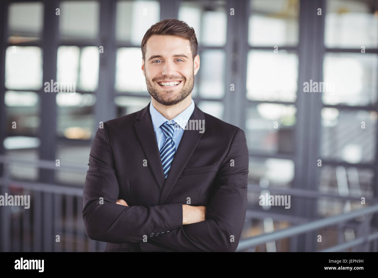 Happy businessman with arms crossed Stock Photo - Alamy