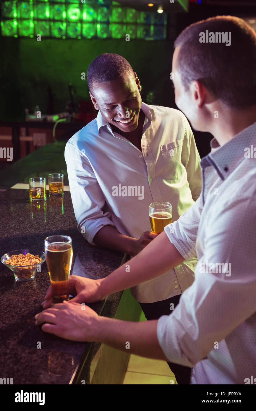 Two men having beer at bar Stock Photo