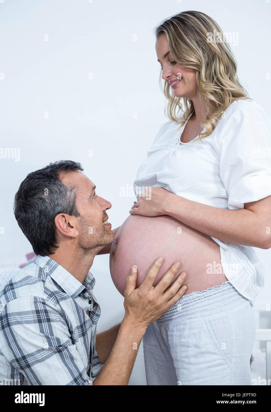 Man touching the belly of pregnant woman Stock Photo - Alamy