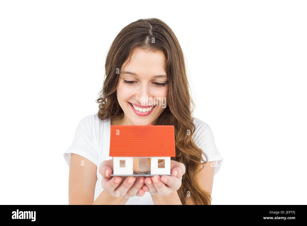 Happy woman holding miniature house Stock Photo - Alamy