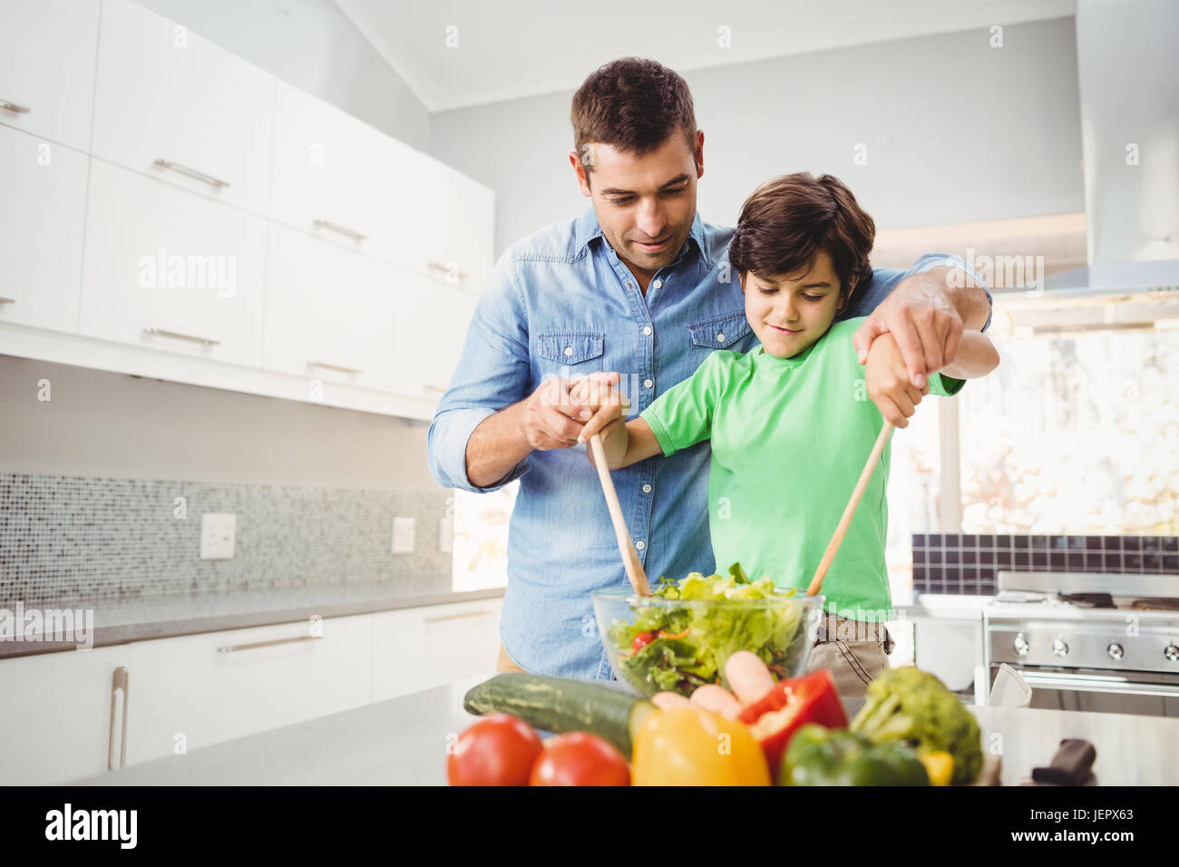 Cheerful Father And Son Preparing Salad Stock Photo Alamy Cheerful Father And Son Preparing Salad Stock Photo Alamy