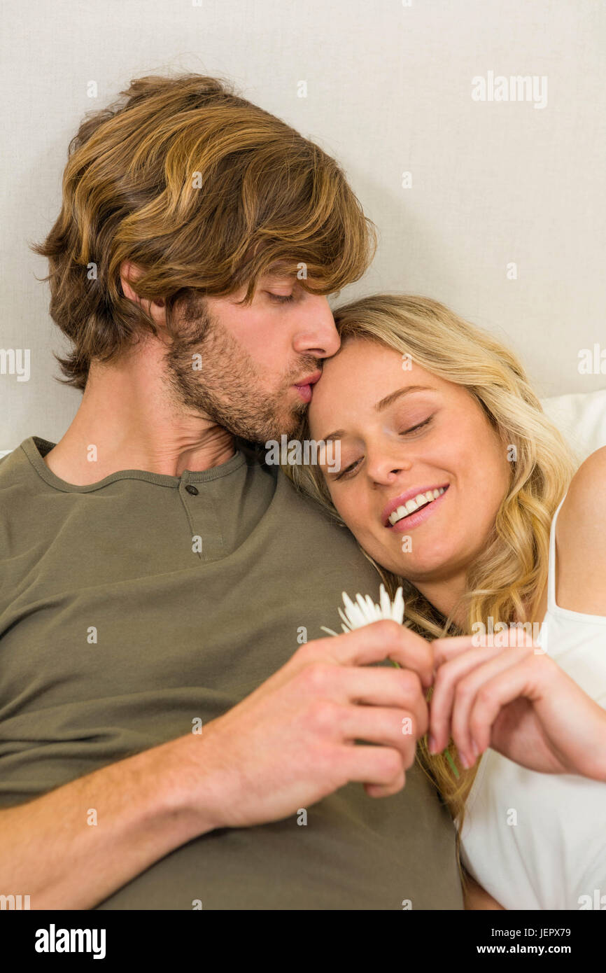 Cute couple cuddling on their bed Stock Photo Alamy