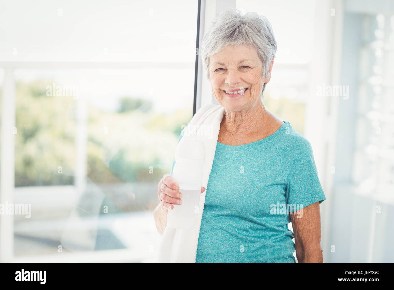 Portrait of smiling woman with towel Stock Photo - Alamy