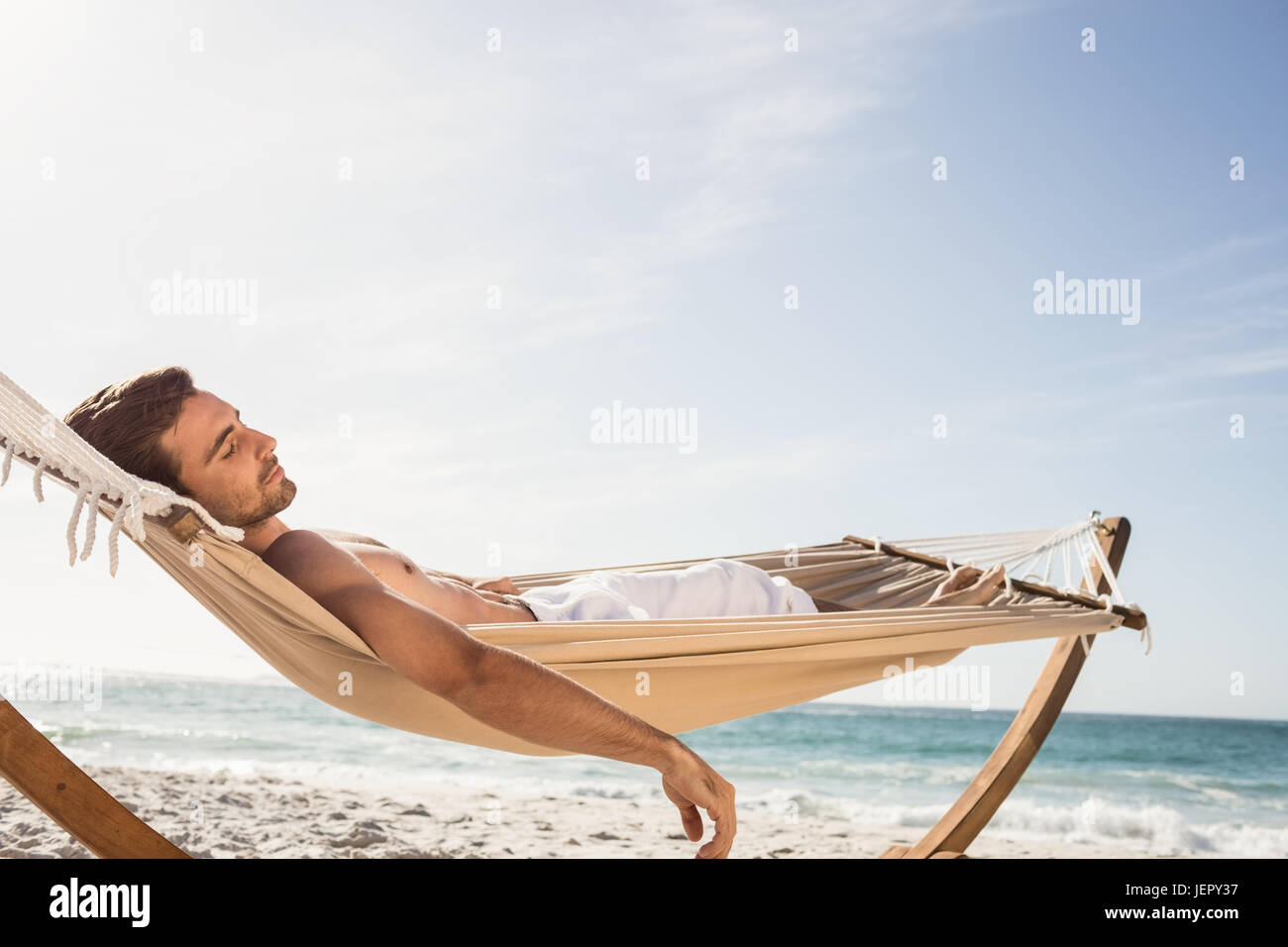 Man sleeping in hammock Stock Photo