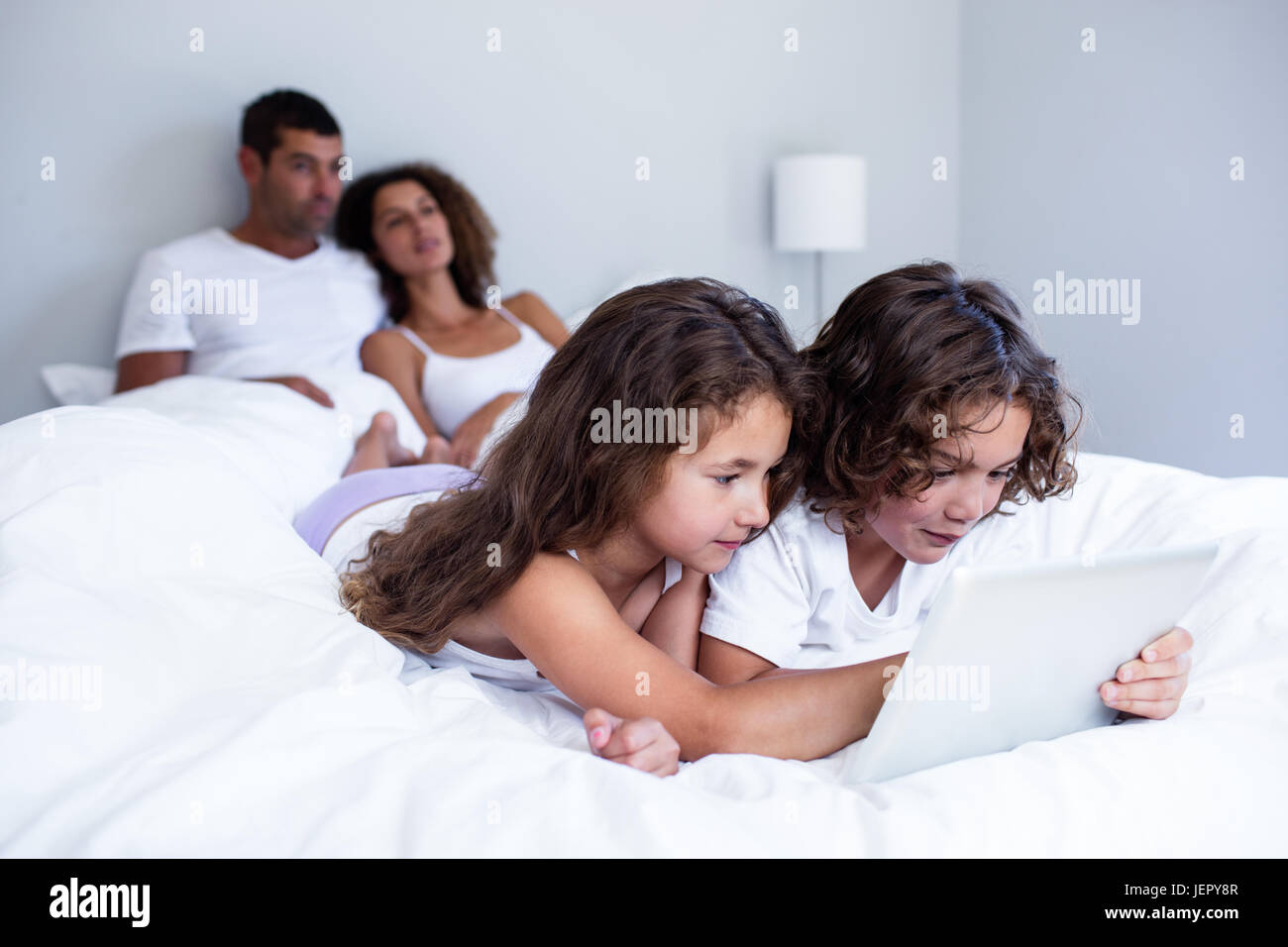 Brother and sister using digital tablet Stock Photo - Alamy