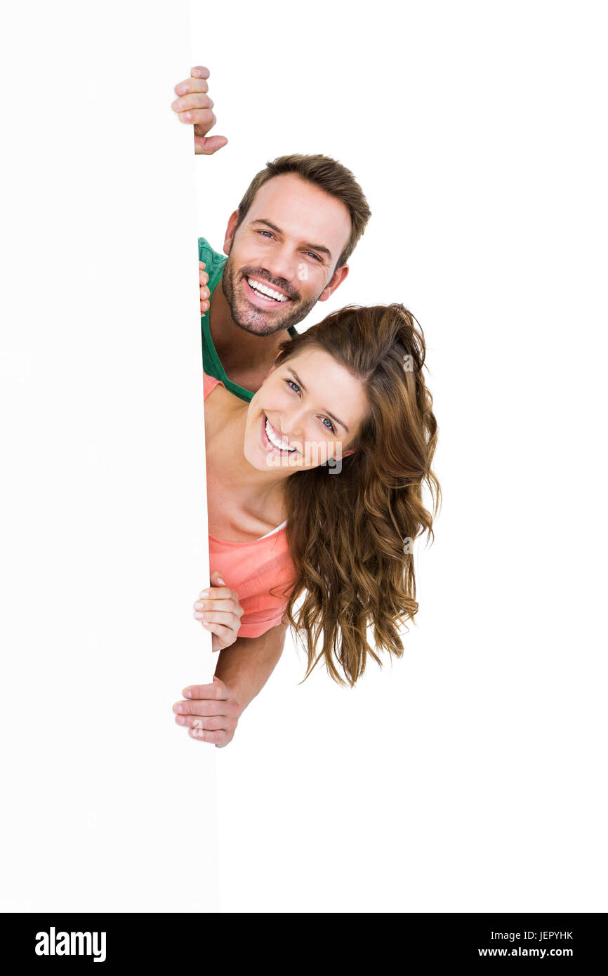Happy young couple smiling at camera Stock Photo - Alamy