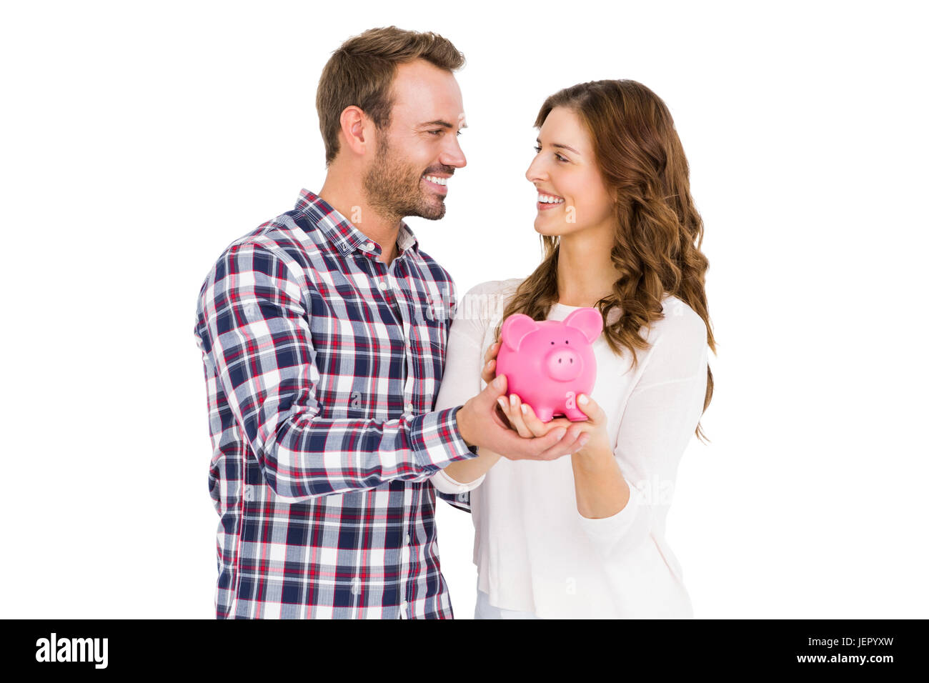 Happy young couple holding piggy bank Stock Photo - Alamy