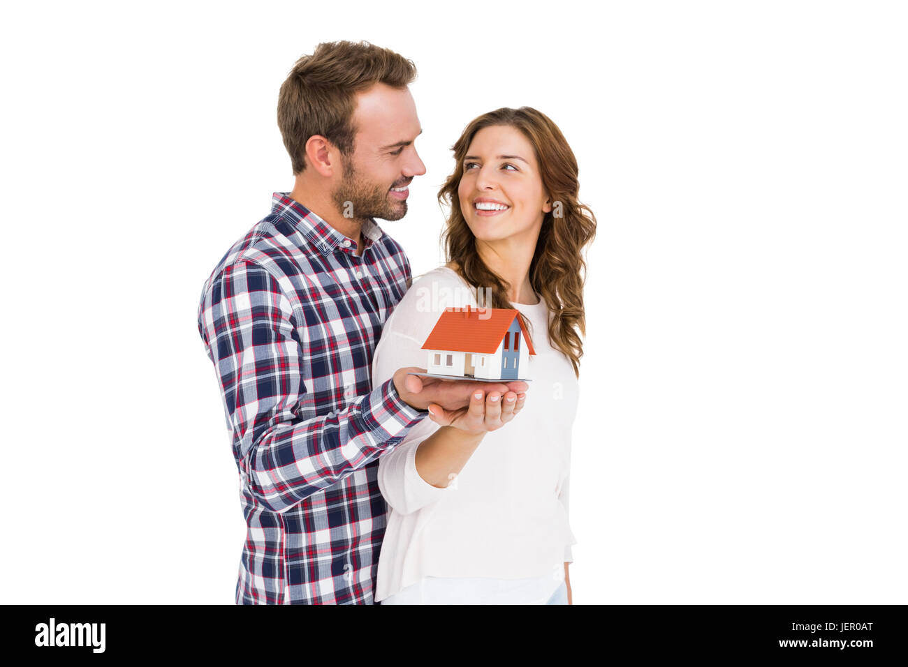 Happy young couple holding model house Stock Photo - Alamy