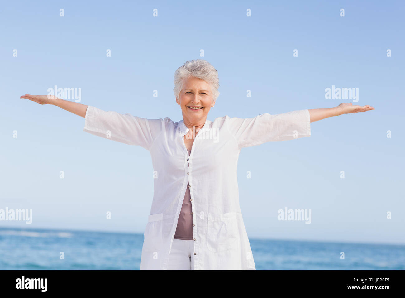 Casual senior woman with arms outstretched Stock Photo - Alamy