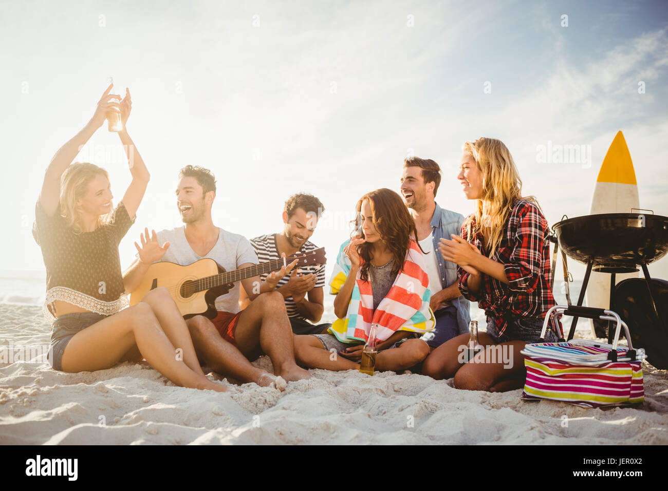 Happy friends having fun near barbecue Stock Photo - Alamy