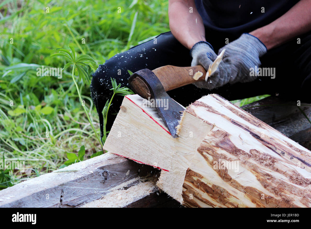 The worker collects a wooden frame with the help of an hacket during ...