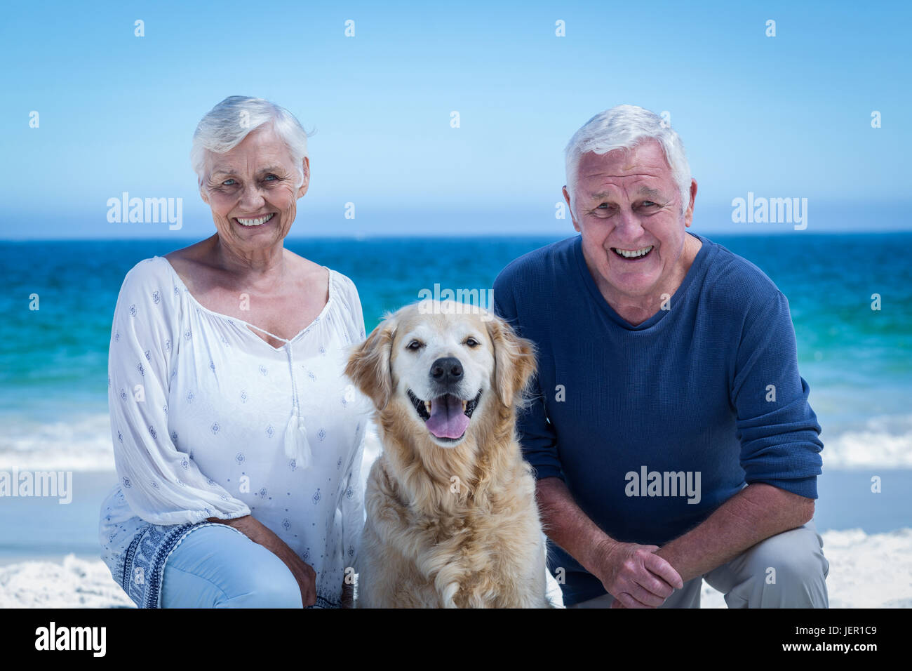 Cute mature couple posing with their dog Stock Photo - Alamy