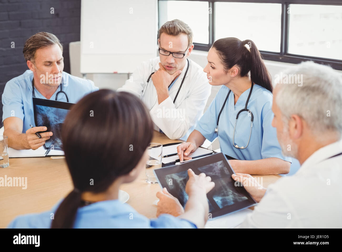 Medical team examining an x-ray report Stock Photo - Alamy
